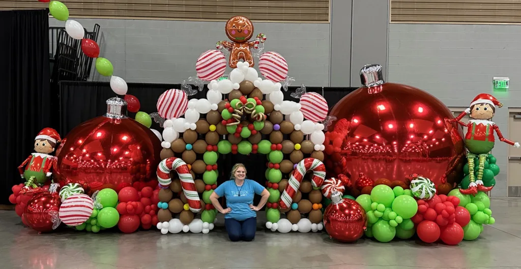 Giant gingerbread house balloon installation with candy canes, ornaments, and lollipops — festive holiday décor by Party Perks STL in St. Louis.