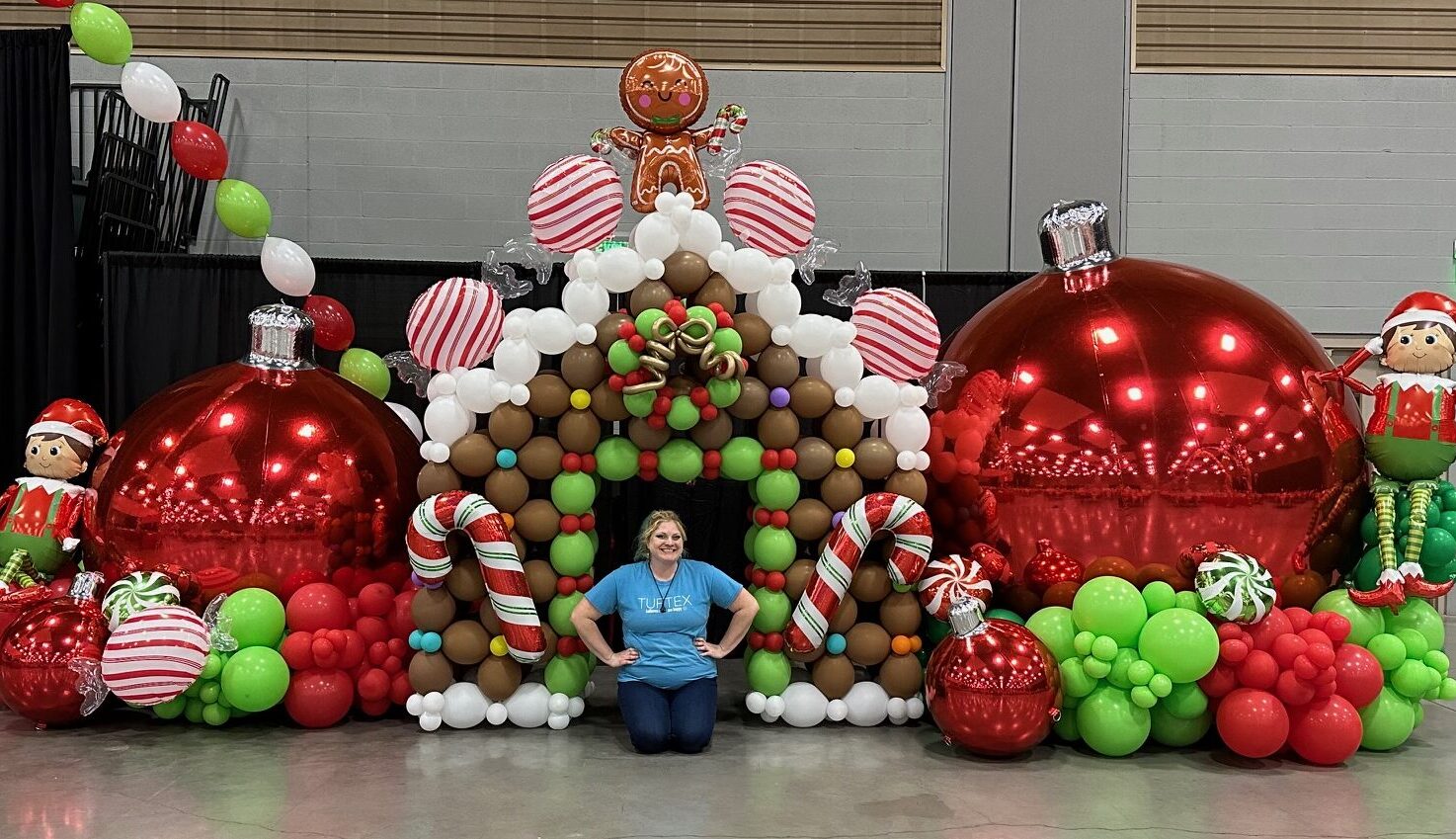 Giant gingerbread house balloon installation with candy canes, ornaments, and lollipops — festive holiday décor by Party Perks STL in St. Louis.