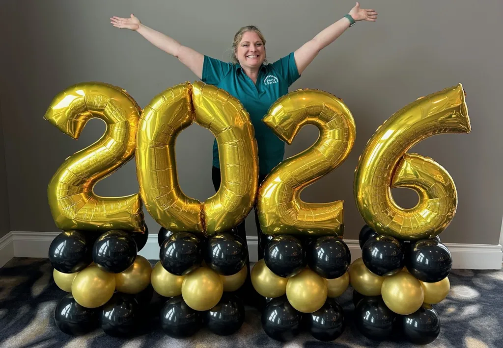 2026 short stack balloon marquee with gold number balloons on black and gold bases for New Year’s Eve décor in St. Louis