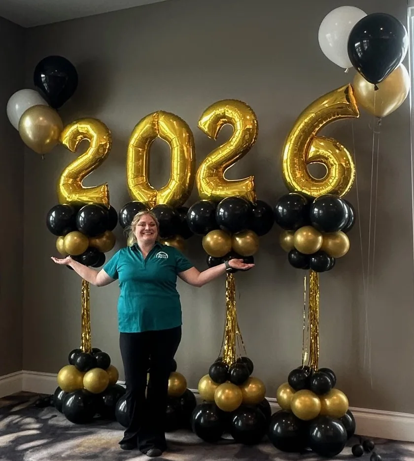 Tall 2026 balloon showstopper columns with gold number balloons and tassel accents for New Year’s Eve décor in St. Louis.