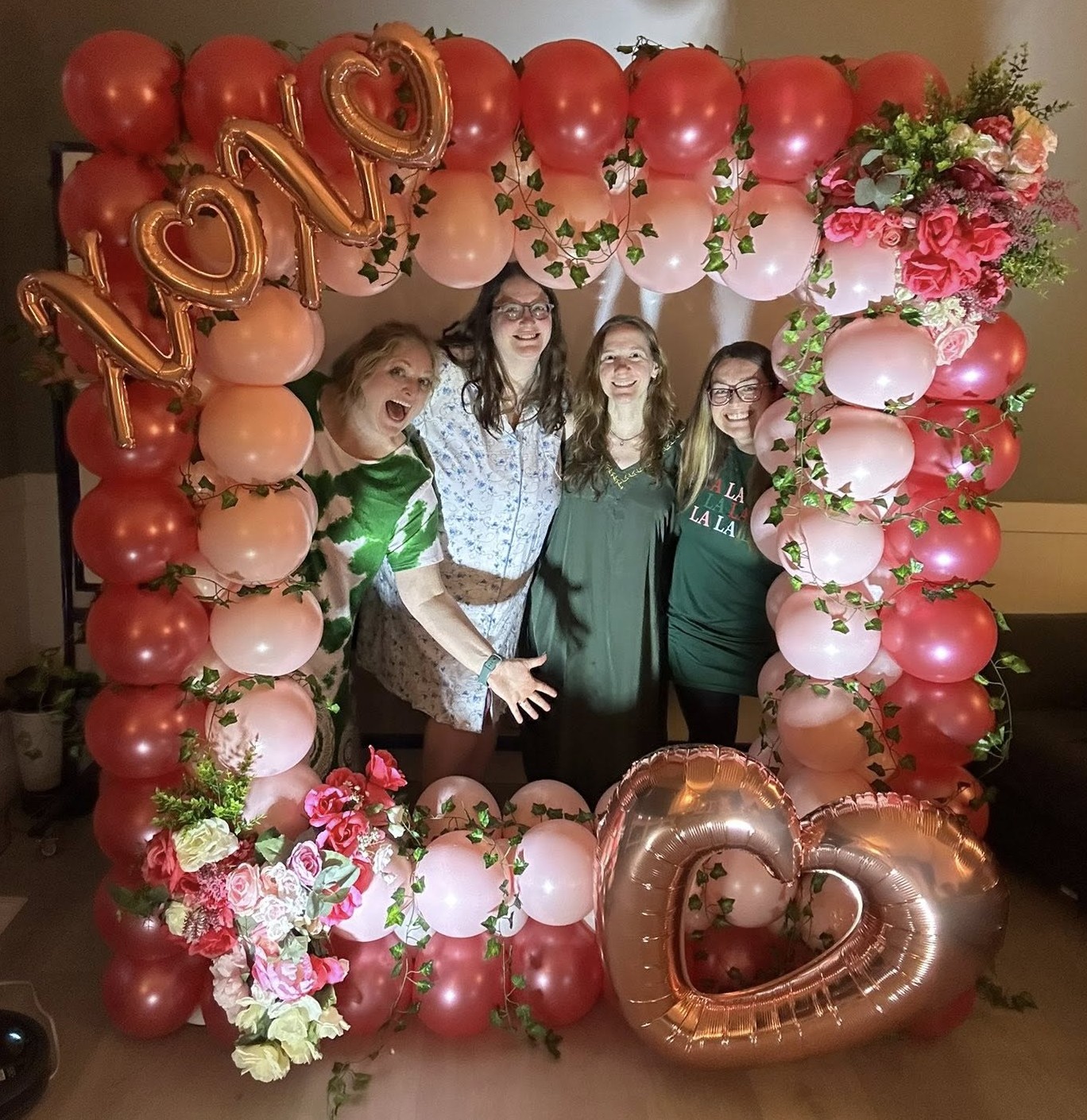 Luxury balloon styling by Party Perks featuring a pink and red Valentine’s balloon photo frame with florals and heart accents at a celebration in the St. Louis area.