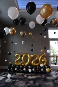 2026 graduation balloon decor in St. Louis with floating helium ceiling balloon strands and gold year numbers for a luxury school celebration.