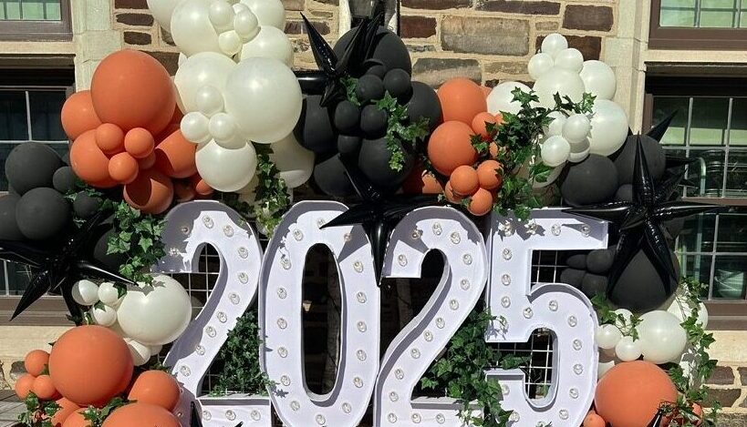 Outdoor 2025 graduation balloon decor in St. Louis with oversized light up marquee numbers, custom balloon styling, and photo-ready backdrop installation.