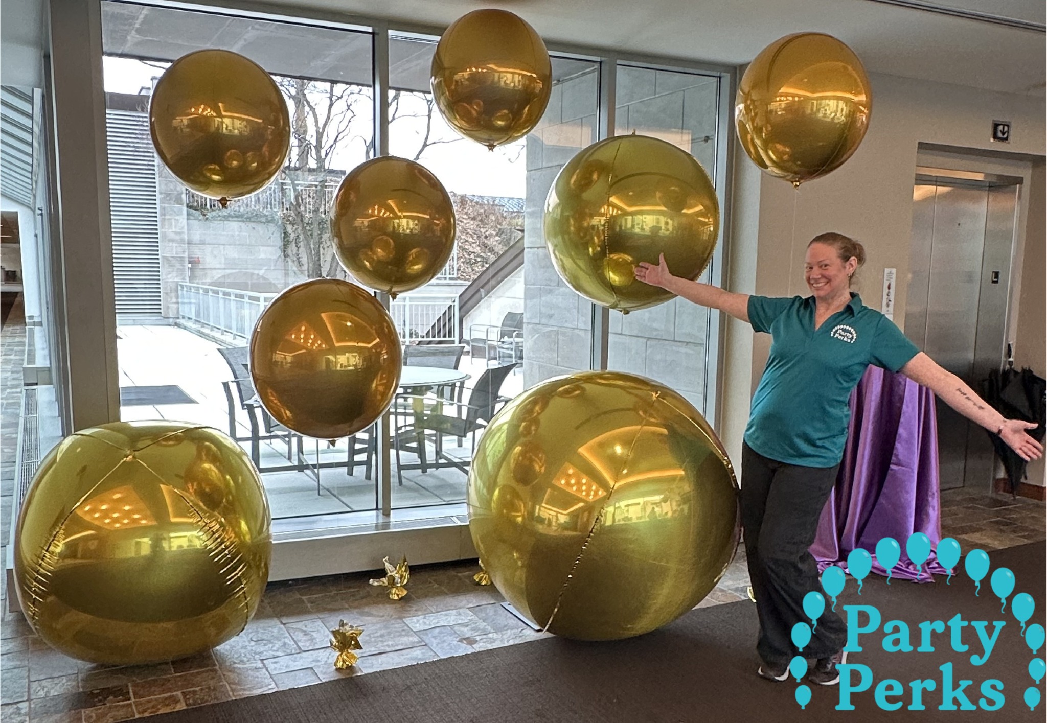 Large gold balloons arranged for Mardi Gras event decorations at a venue in the St. Louis area for a festive celebration.