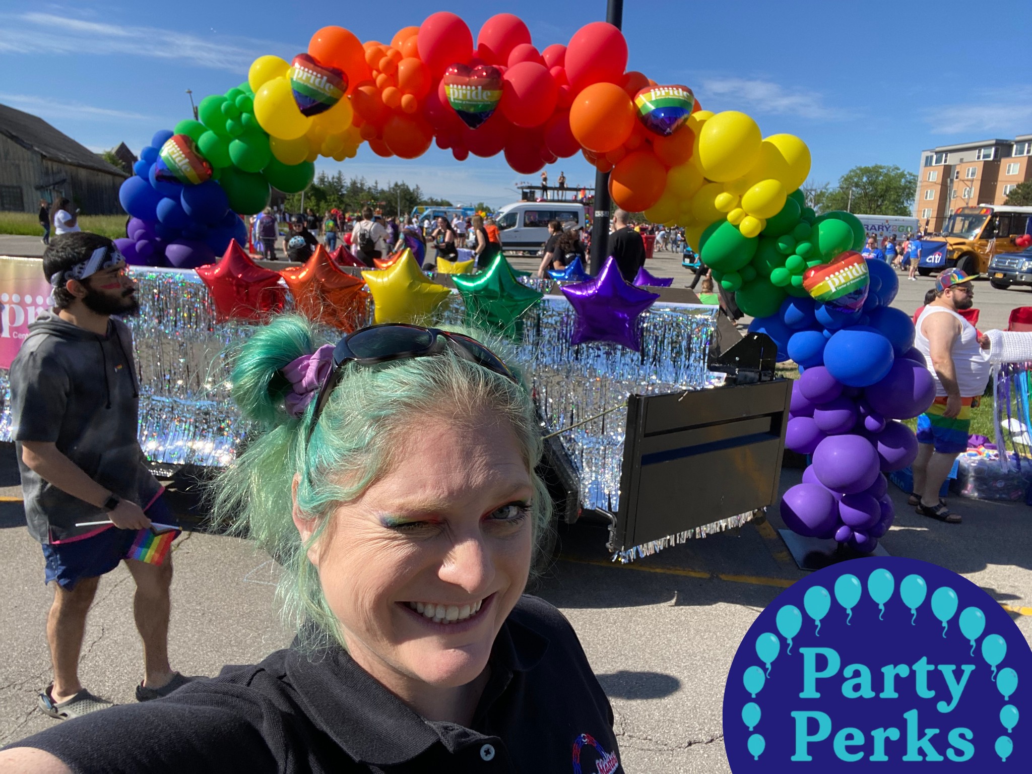 Rainbow balloon arch on Pride parade float during Pride celebration event. event decorations created by St Louis balloon decorator Party Perks